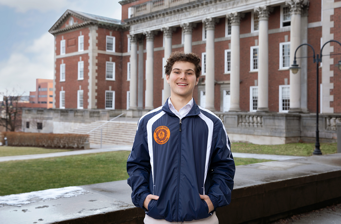 Student standing outside of the Maxwell School.