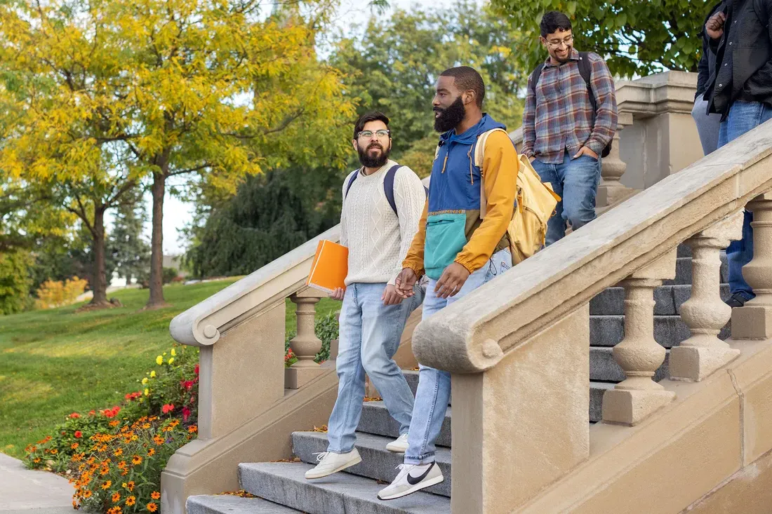 Jurgen Baeza Bernal walking with students on campus.